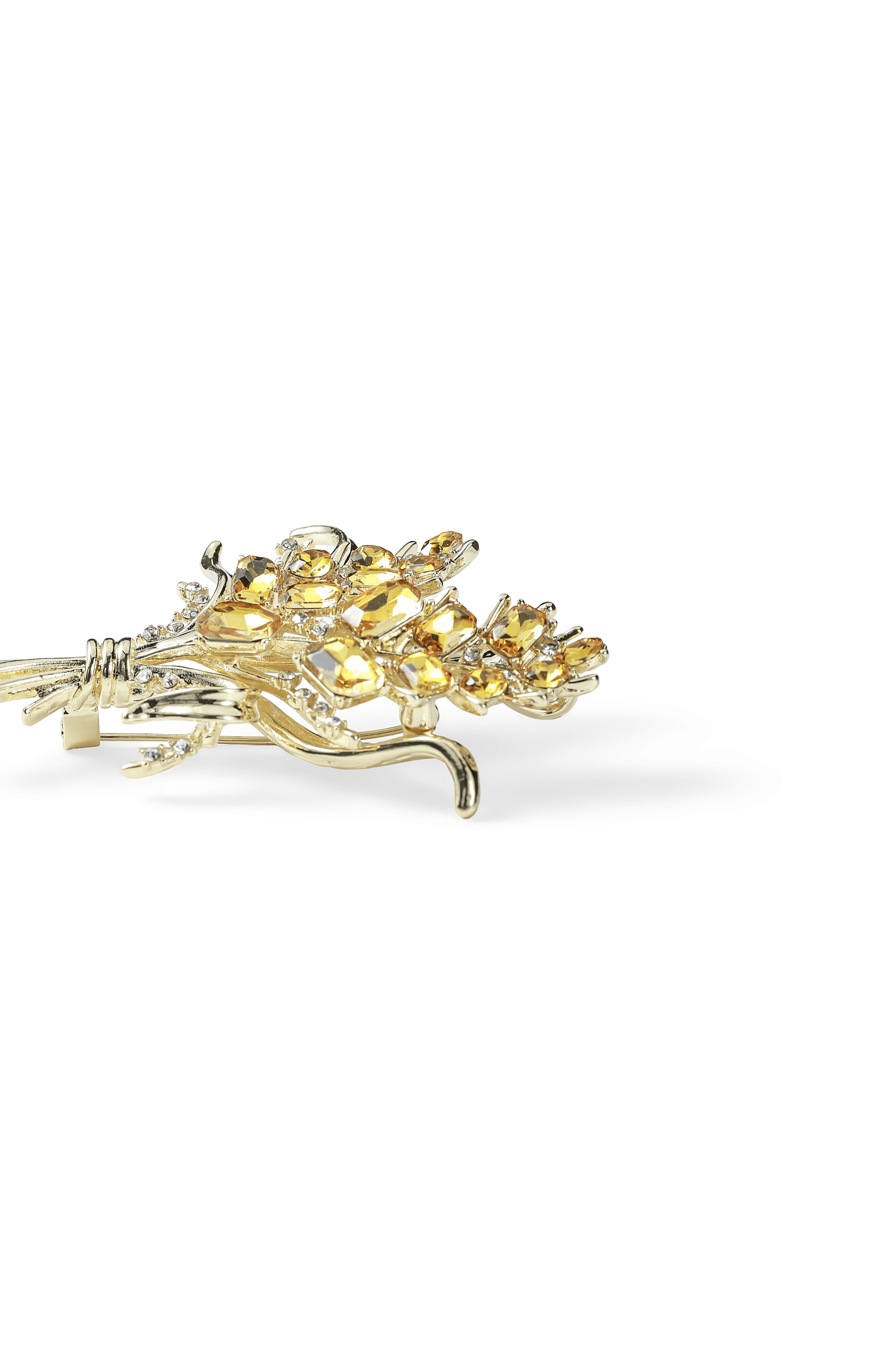 Side view of the Aiko Tanaka Kogane no Minori gold brooch with clustered yellow crystals and slender stems, on white