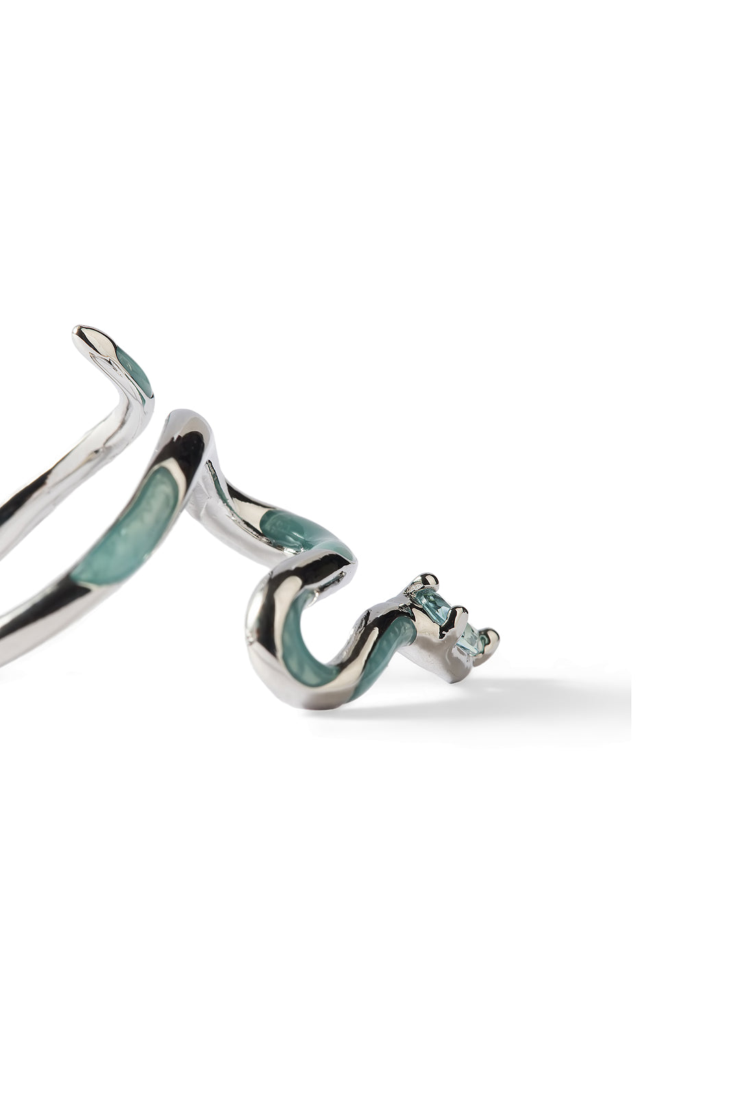 Side view of the Aiko Tanaka Hebi no Nami snake ring in silver with flowing blue-green enamel, on a white background