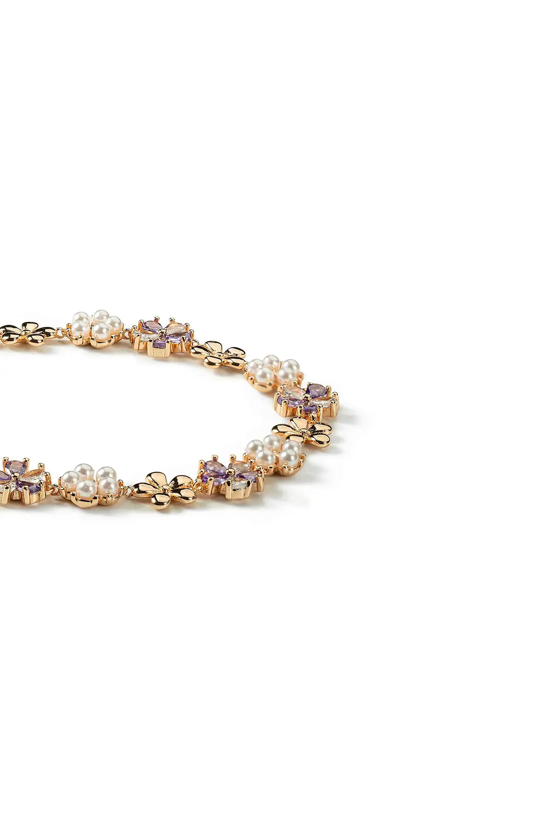 Aiko Tanaka Kasen bracelet side view, linked pink enamel flowers and pearls on a gold chain, white background