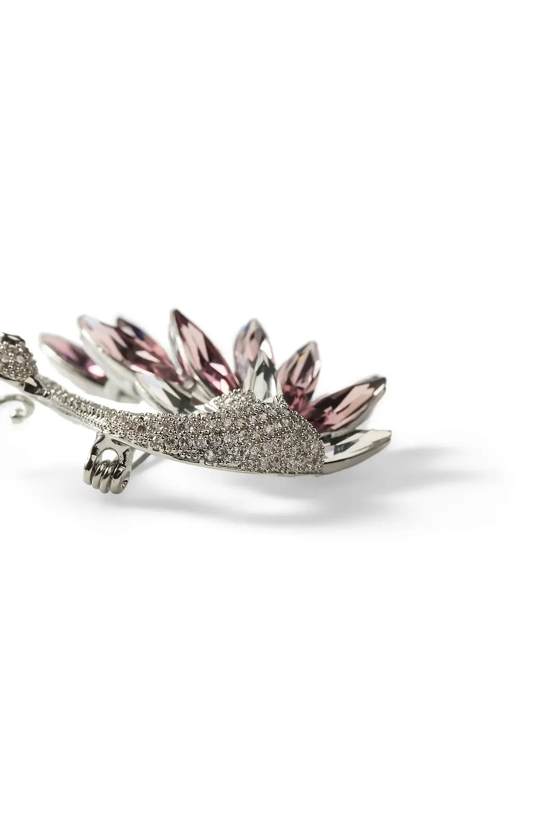Aiko Tanaka Shiraha brooch side view, a silver crystal swan with pink and purple crystal wing feathers, white background