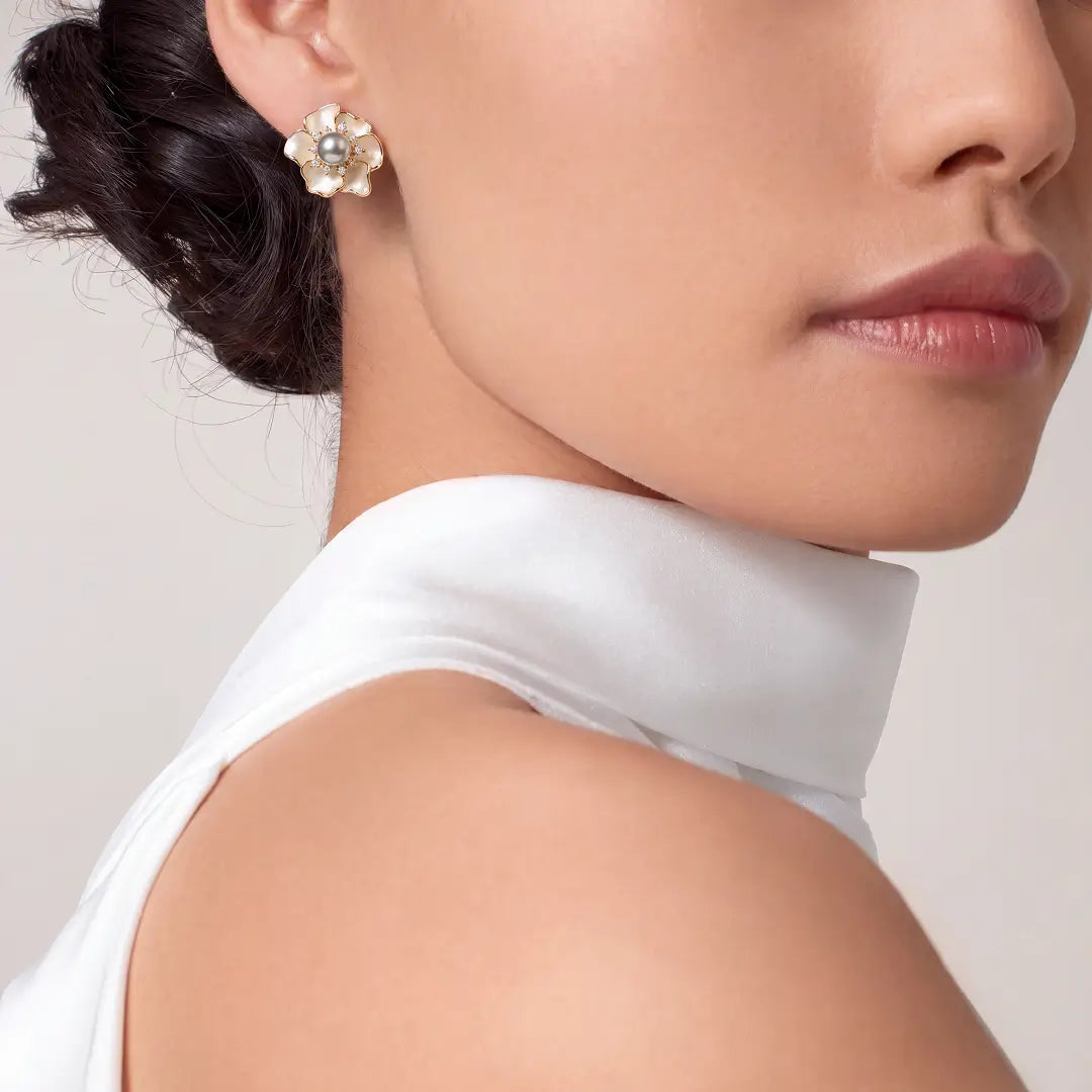 Woman in a white halter top wearing the Aiko Tanaka Koharu mother-of-pearl flower stud earring