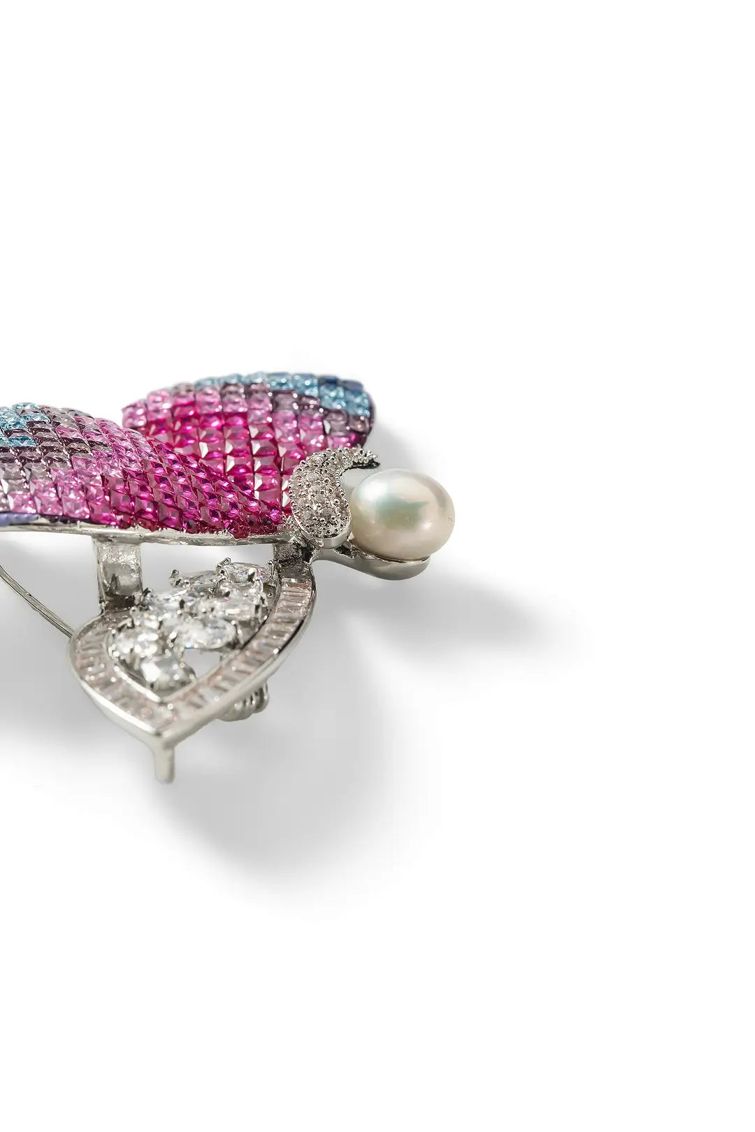 Aiko Tanaka Ageha brooch side view, pink pavé crystal wings with a silver filigree wing and white pearl, white background