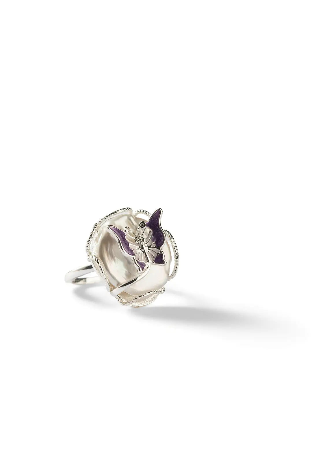 Aiko Tanaka Casane ring, a silver band with a sculpted shell-like face and purple accent, small view on white