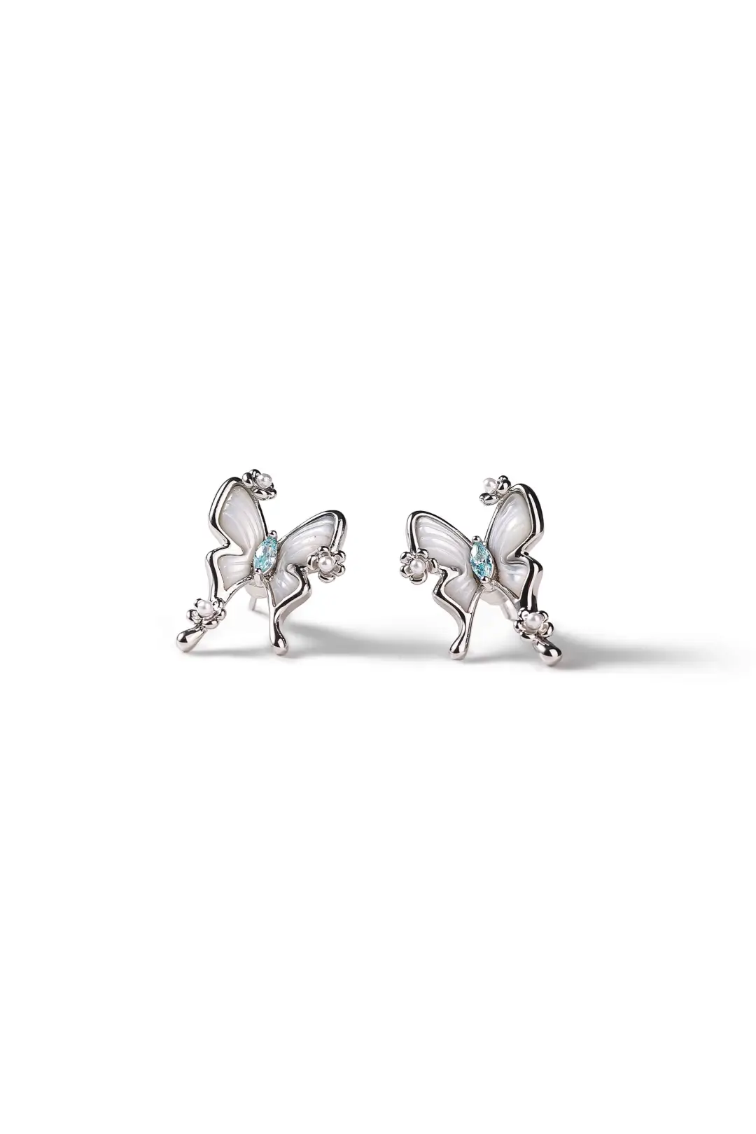 Aiko Tanaka Hakuyo earrings, a pair of silver and mother-of-pearl butterfly studs, on a white background