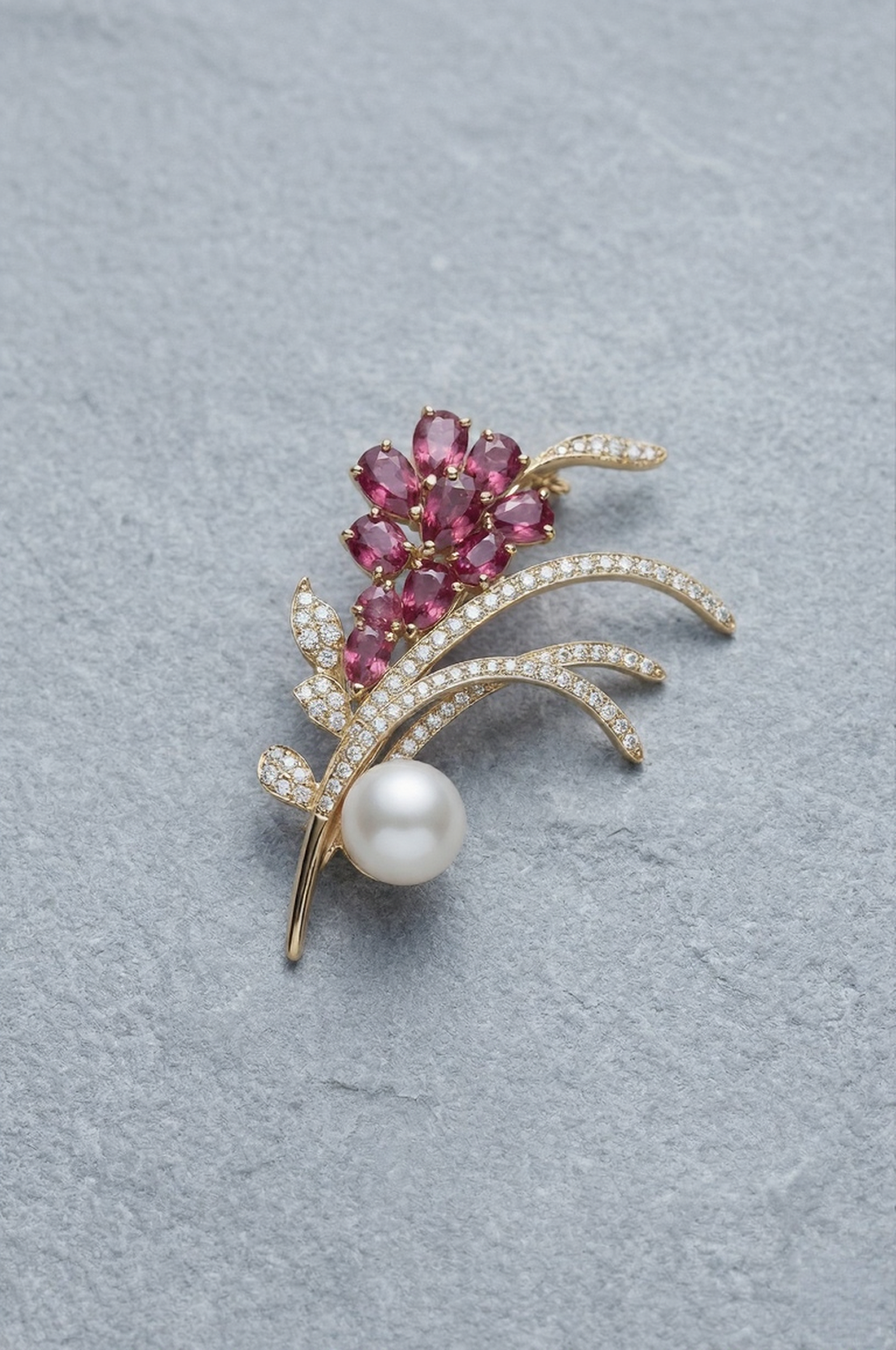 Aiko Tanaka Hana no Nagare brooch with pink crystal flowers, gold pave stems and a white pearl on blue-grey stone