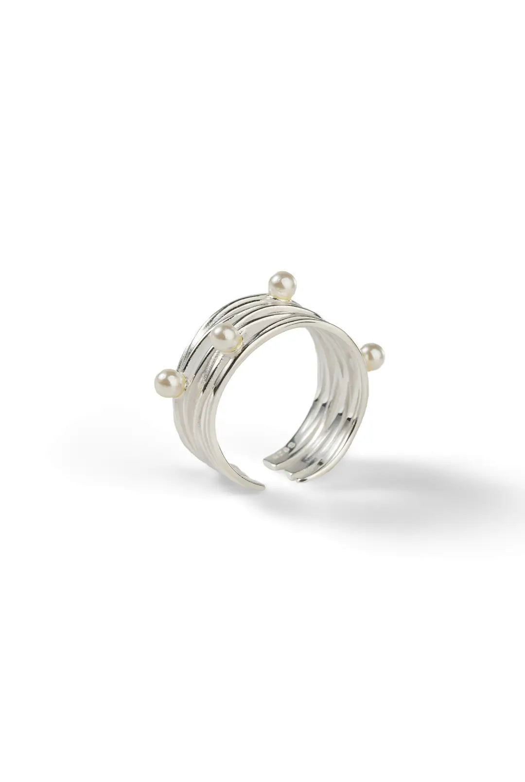 Aiko Tanaka Meguri ring side view, layered silver bands set with tiny white pearls, shown on a white background