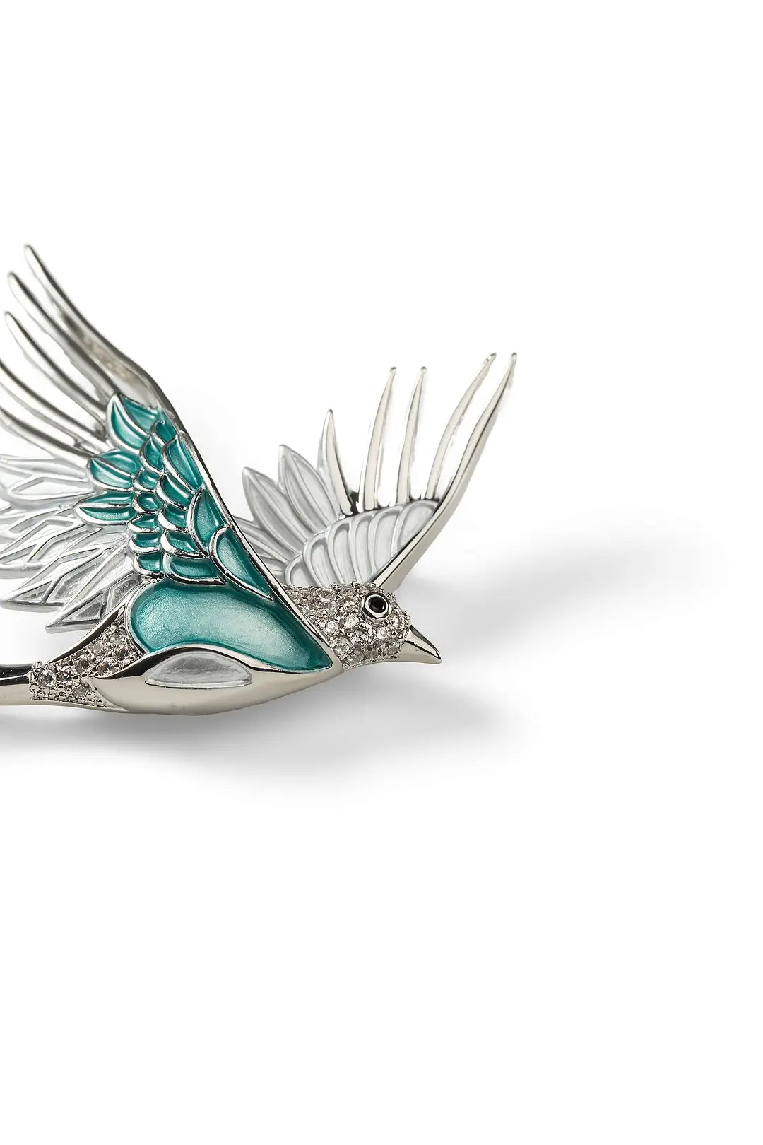 Side view of the Aiko Tanaka Mizuhane silver swallow brooch with teal enamel and crystal feathers, on white