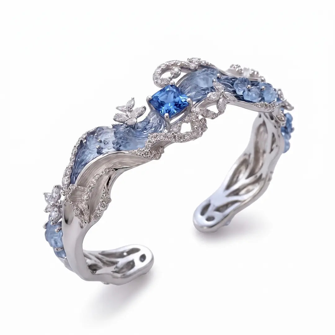 Aiko Tanaka High Jewelry No. 002 cuff angled, flowing silver and blue waves with a blue center stone, on white