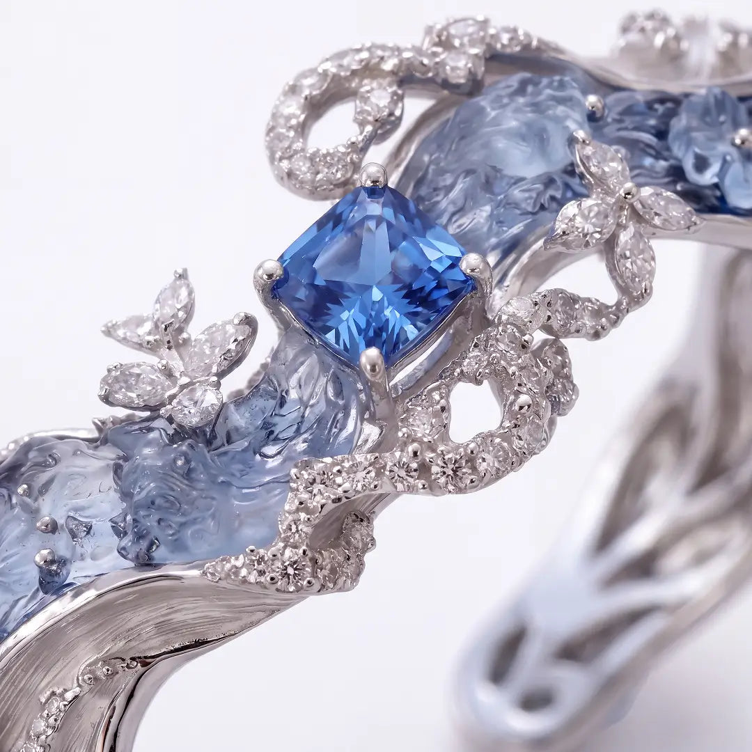 Aiko Tanaka High Jewelry No. 002 cuff close-up, a blue cushion stone set in silver waves with pavé crystals