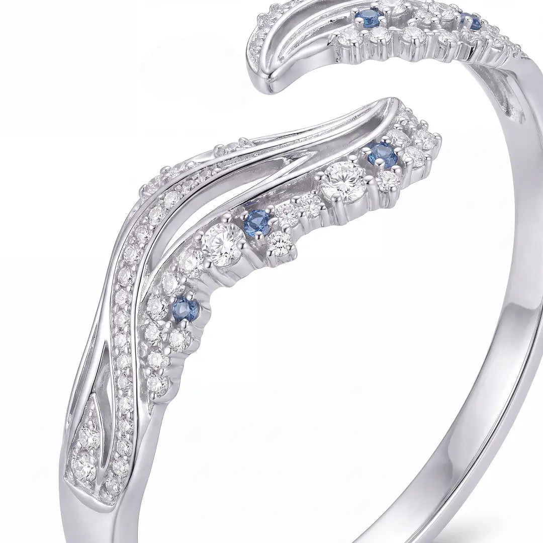 Aiko Tanaka High Jewelry No. 007 bracelet close-up, sweeping silver wave ends set with clear and blue stones