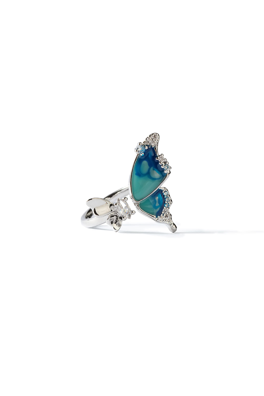 Aiko Tanaka Ran no Cho ring, a silver open band with a blue-green enamel butterfly edged in crystals, on white