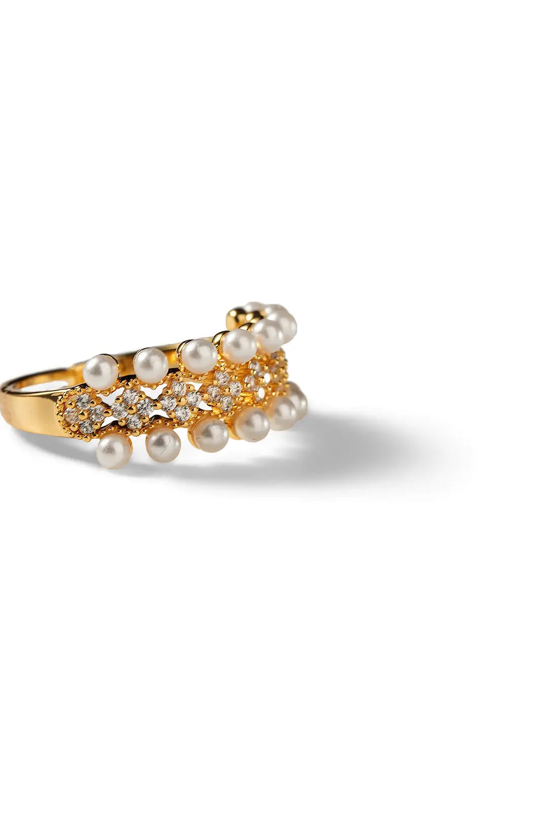 Aiko Tanaka Rinka ring angled view, a gold band crowned with clustered pearls and crystals, on a white background