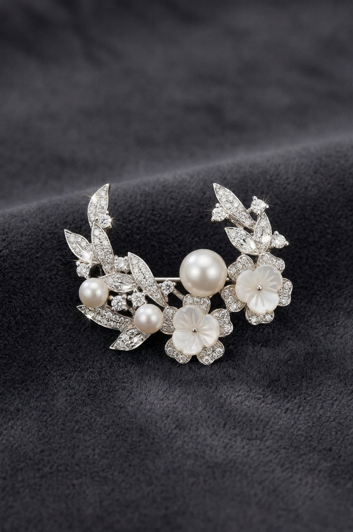 Aiko Tanaka Shiro no Kage crescent brooch with pearls, crystal leaves and mother-of-pearl flowers on dark grey velvet