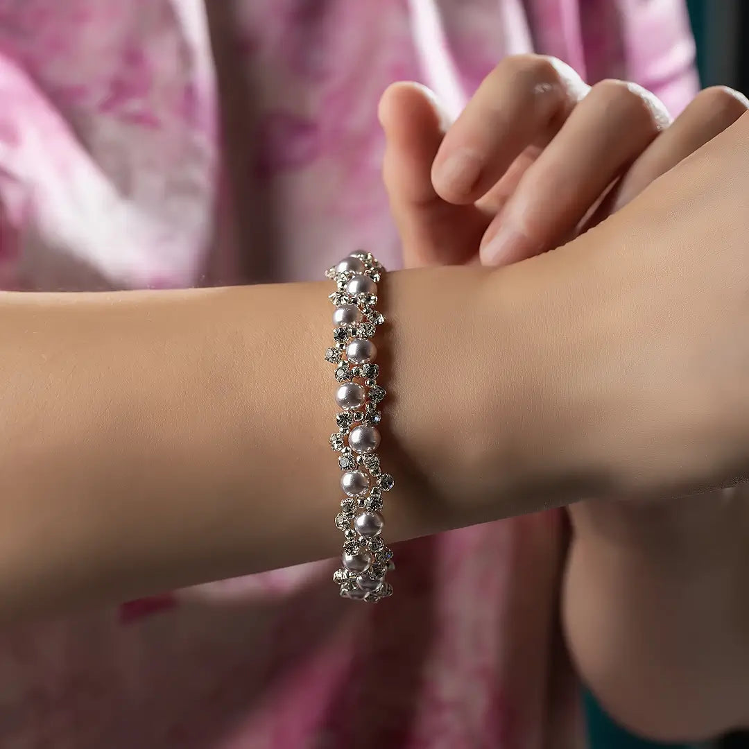 Aiko Tanaka Shirotsuyu bracelet, a silver crystal and pearl bracelet, worn on the wrist with a pink floral blouse