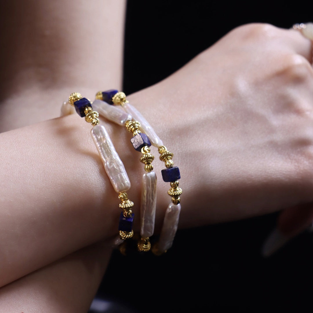 Close-up of a wrist wearing the Aiko Tanaka Shizuku no Kage stick pearl strand as a triple wrap bracelet