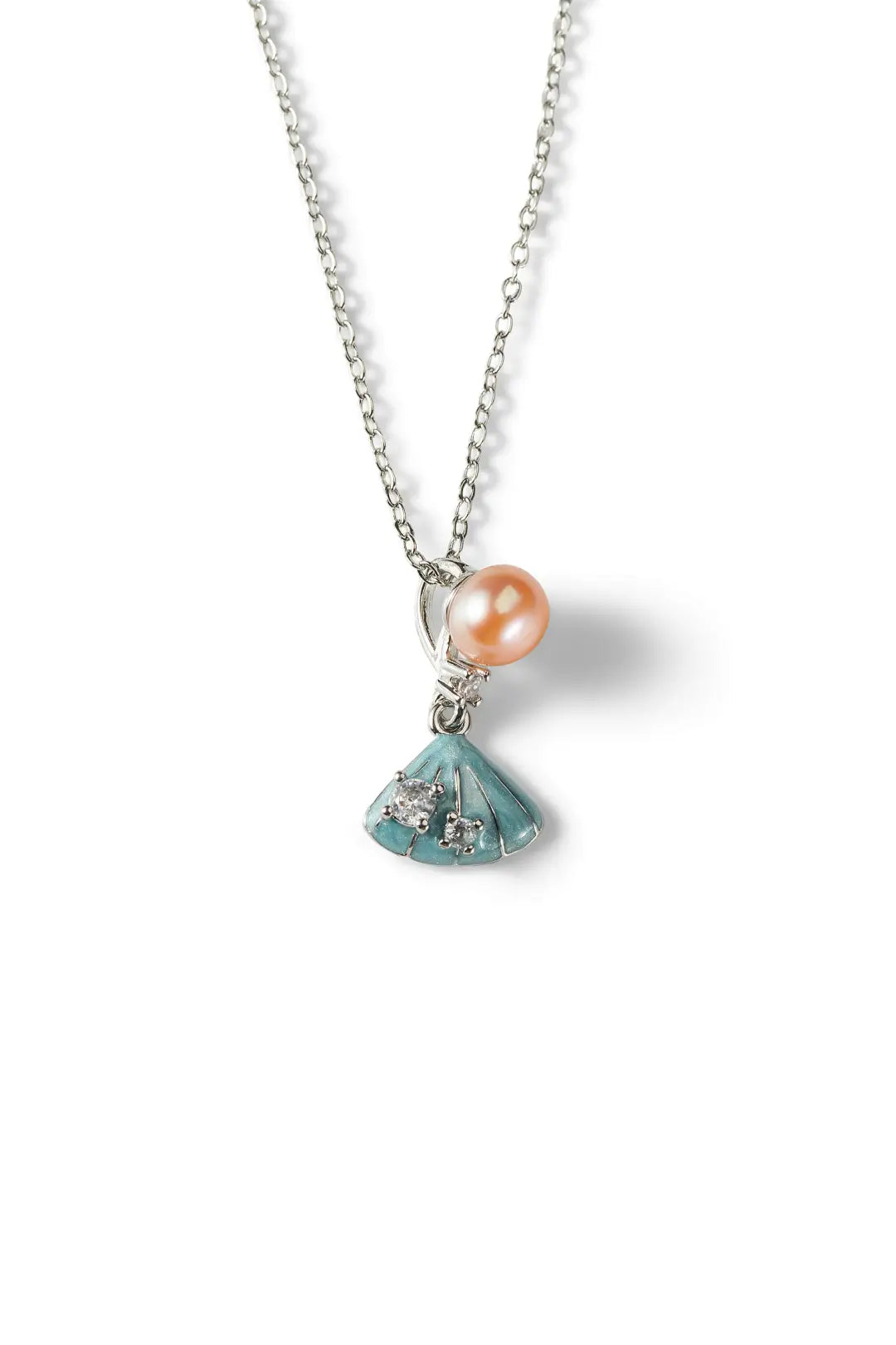 Aiko Tanaka Suiren necklace hanging on a silver chain, showing the peach pearl above a blue enamel lily pad charm