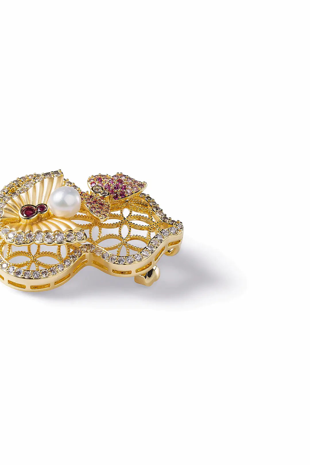 Aiko Tanaka Yugen brooch side view, a gold filigree gourd with pink stone blossoms and a pearl, on white